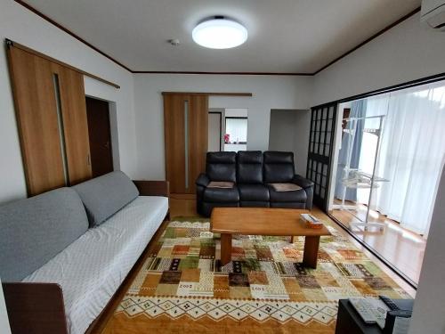 a living room with a couch and a table at Guesthouse Kirishima - Vacation STAY 02754v in Kirishima