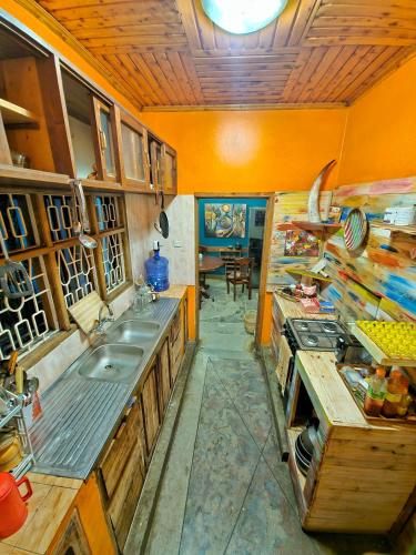 a kitchen with a sink and a stove in it at Mazzola Safari House & Backpacking in Arusha