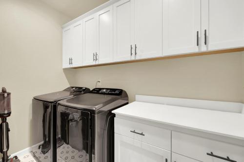 a kitchen with a dishwasher and white cabinets at 1 Mi to Dtwn Winters Home with Fire Pit and Patio! in Winters
