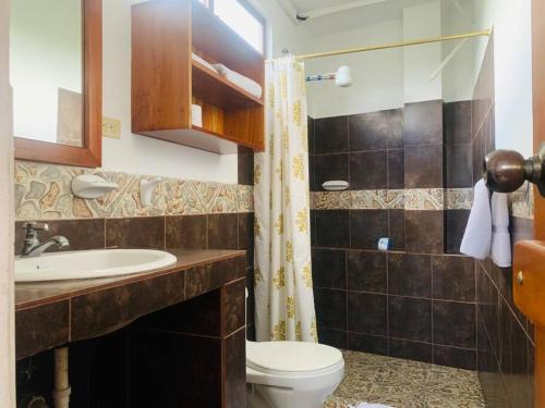 Un baño con inodoro, lavabo y ducha. en Apartamento familiar Galapagos, en Puerto Ayora