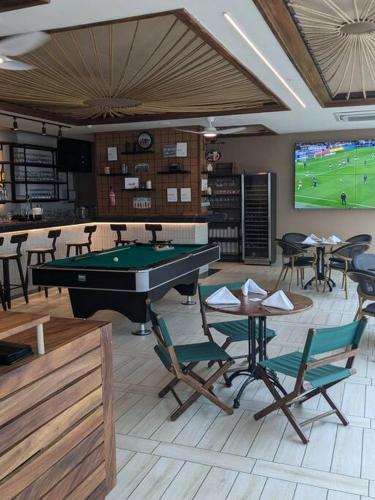 a room with a pool table and a tv at White Sands, Aquamarine waters and High Surfs in Punta Chame