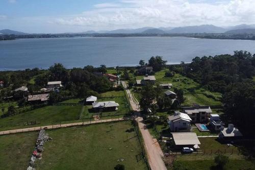 an aerial view of a village next to a body of water at Morada da Lagoa in Garopaba
