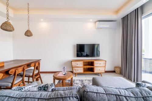 a living room with a couch and a table at Akasia Hill Villas in Nusa Dua