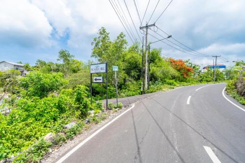 an empty road with a sign on the side at Akasia Hill Villas in Nusa Dua