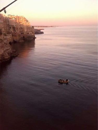 a group of people in a boat in the water at Dimora Dei Gelsi in Polignano a Mare