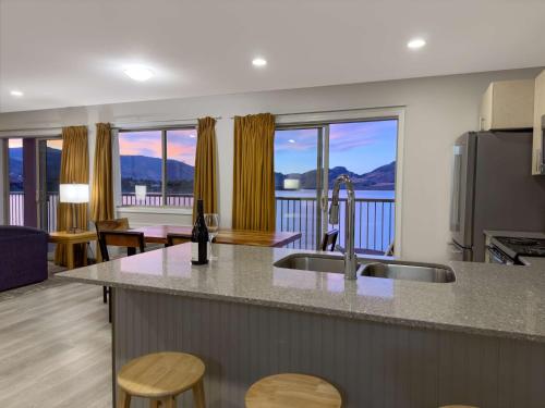 a kitchen with a sink and a counter with a view at Coast Osoyoos Beach Hotel in Osoyoos