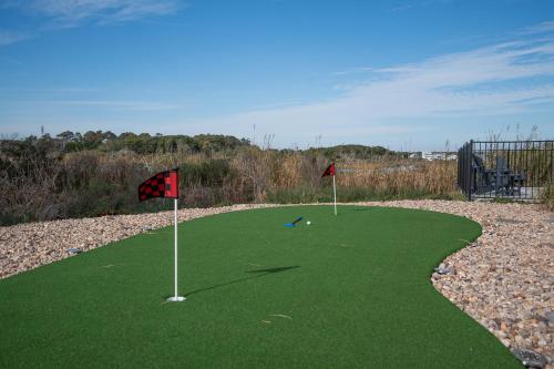 a golf course with two flags on the green at Beachfront Memories by Sea Scape Properties in North Topsail Beach