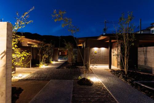 a courtyard of a house at night with lights at 皆玉邸 恵 in Sakaiminato