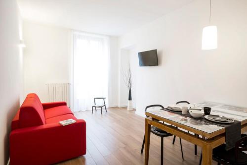 a living room with a red couch and a table at TorinoToStay Apartments in Turin