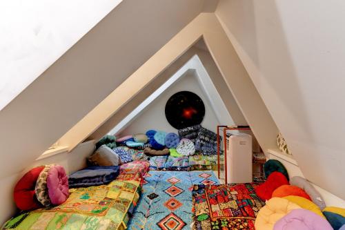 a room with a pile of stuffed animals on a bed at Beach Paradise Getaway - 200ft from Beach! in Sebastian