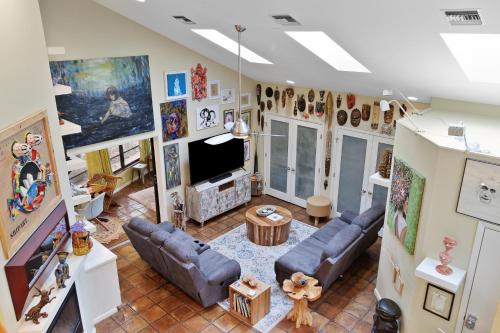 a living room with couches and a tv at Beach Paradise Getaway - 200ft from Beach! in Sebastian