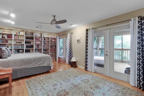 a bedroom with a bed and bookshelves at Beach Paradise Getaway - 200ft from Beach! in Sebastian