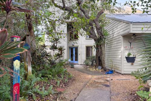 a white house with a pathway leading to it at Beach Paradise Getaway - 200ft from Beach! in Sebastian