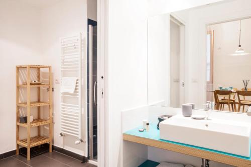 a bathroom with a white sink and a mirror at TorinoToStay Apartments in Turin
