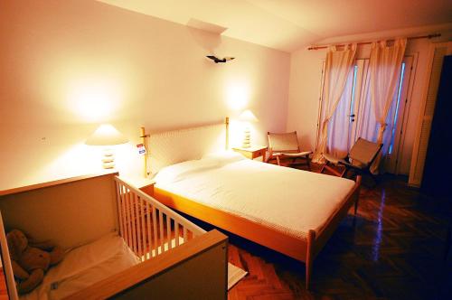 a bedroom with a bed and a crib in it at Holiday Home Valica in Malinska