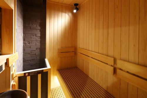 a small sauna with a bench in a room at global cabin Yokohama Chinatown in Yokohama