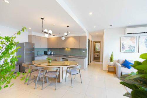 a kitchen and living room with a table and chairs at The Song Luxury Apartment Vung Tau - Siêu ưu đãi chỉ có trong tuần nay in Vung Tau