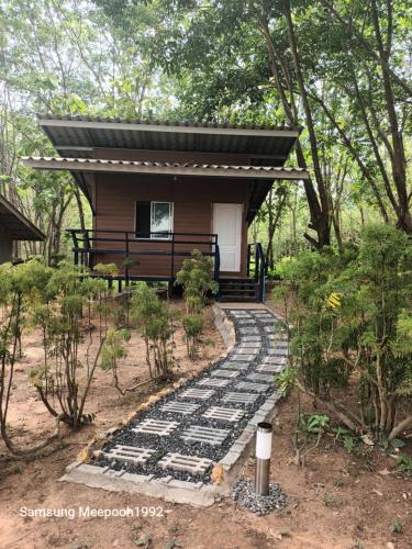 a small house with a bench and a walkway at PhaluayCamping in Koh Phaluai