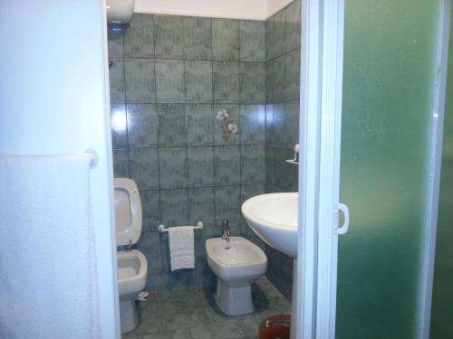 a bathroom with a toilet and a bidet and a sink at Villa Betta in Cittadella del Capo