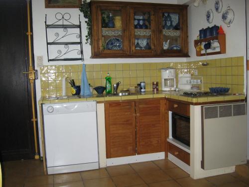 a kitchen with a white refrigerator and a white dishwasher at T3 vue mer exceptionnelle in Cassis
