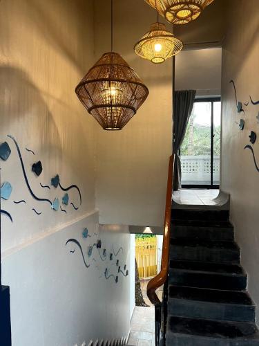 a staircase with blue birds painted on the wall at La Sataqui in Cansaulim