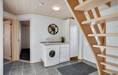 a washing machine in a laundry room with a staircase at Amazing Home In Skjern With 5 Bedrooms, Sauna & Wifi in Skjern