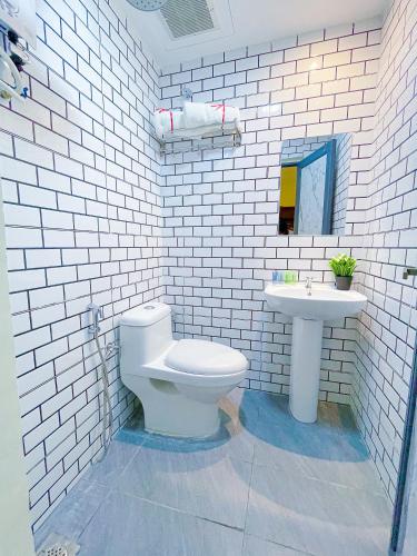 a white bathroom with a toilet and a sink at Astar Hotel Kuala Lumpur in Kuala Lumpur