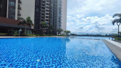 a large blue swimming pool with buildings in the background at R&F Princess Cove View Residences by WSD in Johor Bahru
