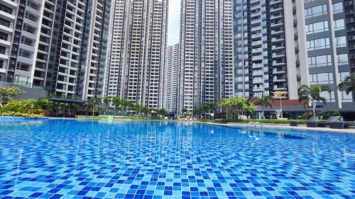 a large blue swimming pool with tall buildings in the background at R&F Princess Cove View Residences by WSD in Johor Bahru