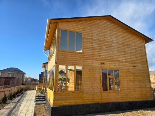 a wooden house is being built on a street at Wood House 2 in Bosteri
