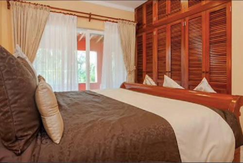 a bedroom with a large bed and a window at 5 BD Luxury Villa with Large Pool & Minutes from Beach in Puerto Aventuras