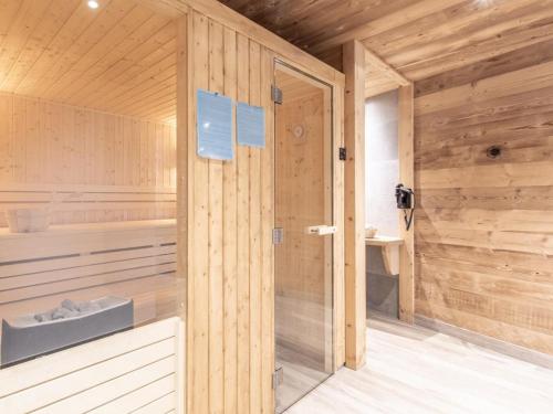 un sauna avec un mur en bois et une porte dans l'établissement Appartement spacieux avec sauna et spa, proche des pistes - FR-1-467-143, au Grand-Bornand