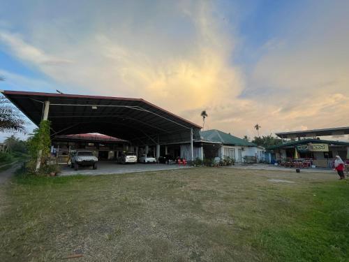 a building with a car parked in a parking lot at Aravilla Homestay Double in Kota Belud