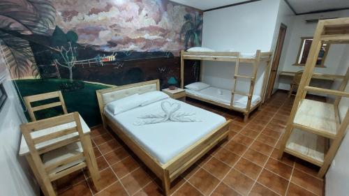 a room with two bunk beds and a mural at Seaview Moonrise Café in Alcoy