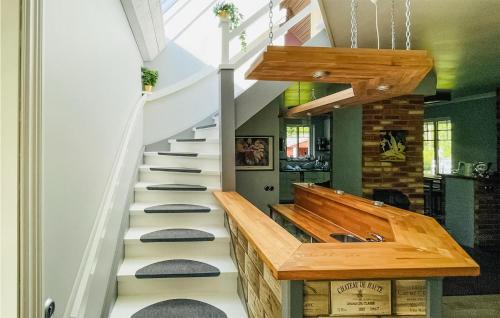 a staircase in a house with a wooden stair case at Gorgeous Home In Laholm With Kitchen in Laholm