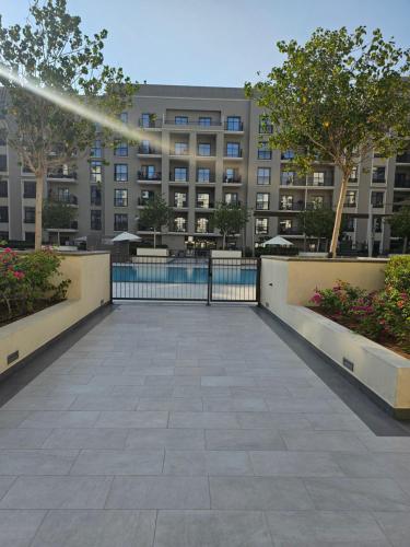 a large building with a pool in front of it at Apartments 100 m2 in Sharjah