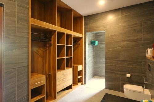 a bathroom with a toilet and a shower at Saujana, Beachvilla with 3 bedrooms in Singaraja