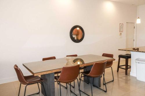 a dining room table with chairs and a mirror on the wall at La Isla C206 condo in South Padre Island