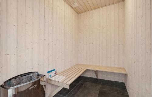 a room with a bench and a trash can at 5 Bedroom Lovely Home In Højslev in Højslev