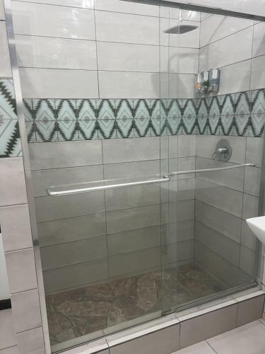 a shower with a glass door in a bathroom at Chalet Belizomi Tropical Villas Studio Villa #3 in Gros Islet