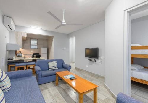 a living room with a couch and chairs and a table at Shaka Shores 7E in Durban