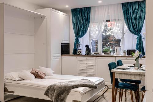 a bedroom with a bed and a desk in a kitchen at Sika Garden Apartment - cazare Arad - self check-in in Arad
