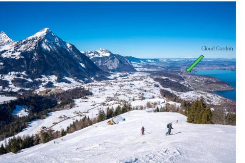 a group of people skiing down a snow covered slope at Cloud Garden Maisonette in Spiez