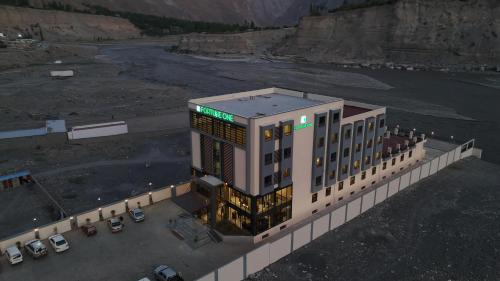 an overhead view of a building with cars in a parking lot at Fortune One Hotel in Hunza