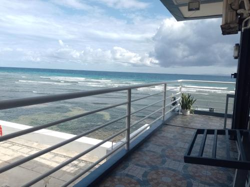 a balcony with a view of the ocean at Angler's Hub & Resort Oslob in Oslob