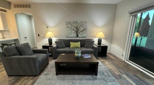a living room with a couch and a coffee table at Desert Princess Serenity Suite in Cathedral City