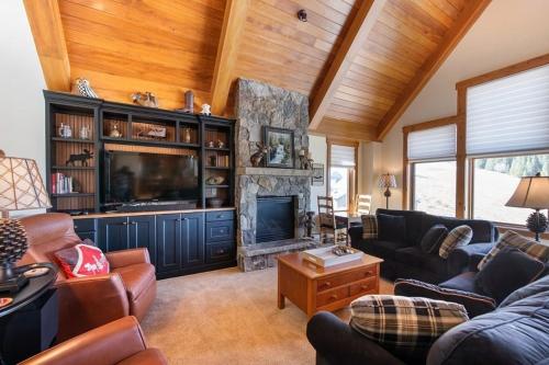 a living room with a couch and a fireplace at Premium Unit 2801 - Zephyr Mountain Lodge condo in Winter Park