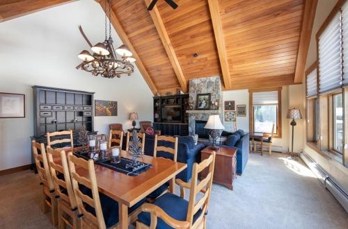 a dining room and living room with a wooden ceiling at Premium Unit 2801 - Zephyr Mountain Lodge condo in Winter Park