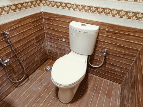 a bathroom with a white toilet in a room at Ramana's Home Stay-Near Railway Station and Bus Stand in Thanjāvūr