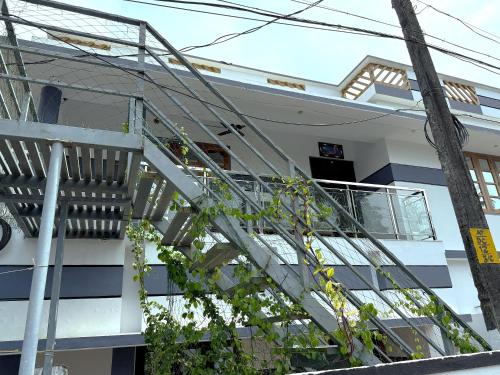a staircase in front of a building at Paddy N Canal Homestay in Alleppey